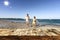 Mum and kid on the beach. Table background with beautiful blue ocean and sandy beach view. Summer sunny day.