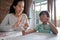 Mum and kid learning maths together at home