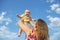 Mum lifts a child in his arms against the sky. Having fun outdoors, love and happiness concept