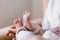 Mum making baby massage, mother massaging infant bare foot, preventive massage for newborn
