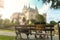 Mum siting on bench on background of beautiful castle