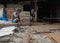 Mumbai,India,August-8-2019: A labourer sitting out idle outside his asbestos sheet shop due to lack of customers and fallen