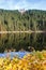 Mummelsee lake and mountain Hornisgrinde in Seebach in the Black Forest landscape nature autumn fall portrait format in Germany