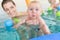 Mums and babies having fun at infant swimming course