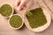 Mung bean seeds in wooden spoon holding by hand