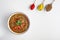 Mung Dhal with red pepper slices isolated at white. Moong Dal - Indian Cuisine curry