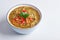 Mung Dhal with red pepper slices isolated at white. Moong Dal - Indian Cuisine curry