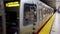 Muni subway train stopping at Castro station while commuters waiting, San Francisco