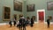 Munich, Germany - December 17, 2019: A group of visitors to art lovers discuss paintings. Old Pinakothek. Exposition of