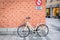 Munich, Germany. February 17, 2019. Bicycle on the brick wall background. Inscription in german prohibition sign no parking