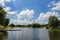 Munich, Germany - July 6, 2022: View across the Olympic Lake to the Olympic Stadium. The Olympiapark is used by the residents of M