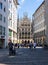 Munich, Germany - July 6, 2022: View through the alley of Rindermarkt up to Marienplatz with the new town hall. Tourists on the