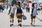Munich, Germany-September 27,2017: Three men in traditional bavarian clothes leather pants walk on the Oktoberfest