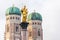 Munich, Germany - View of Towers of Munich Cathedral and the Golden Statue of Mary at Marienplatz in Munchen, Bavaria, Germany
