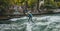 MUNICH - SEPTEMBER 19: surfer works the wave at the eisbachwell standing wave SEPTEMBER 19, 2019 in Munich