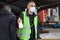 Municipal employee with mask and disinfectant in a public place helping people with protection and prevention of spreading