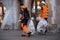 Municipal employees walking in the street with garbages in a plastic bags  in hands