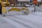 Municipal service tractor removing snow on street after snowfall