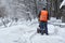 Municipal worker removing snow from the moscow street using snow blower