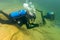 Munising, MI -August 14th, 2021: SCUBA diver checking gauges underwater