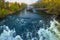 Mur river in autumn, with Murinsel bridge and old buildings in the city center of Graz, Styria region, Austria