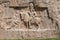 Murals of Necropolis, king burial site of ancient Persia. King on his horse carved into sandstone rock wall.