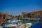 MURANO, ITALY - JUNE 16, 2015: Various boats parking on Murano canals outside of people houses, nice view in sunny day