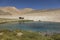 Murghab, Tajikistan, August 23 2018: Tajik sits at a spring near Alichur in the Pamir Mountains and enjoys the beautiful view
