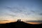 Murmuration of starlings over fairytale castle ruins in sunset l