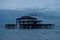 Murmuration of starlings over the remains of West Pier, Brighton UK. Photographed at dusk.