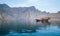 Musandam, Oman - 04.01.2018: People on a traditional arabian dhow boat sailing in the fjords of Musandam, Oman. Hazy day