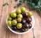 Muscadine grapes are also known as swamp grapes, Florida grapes in a bowl on wood background