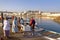 MUSCAT, OMAN - FEBRUARY 11, 2012: Fisherman at The Muttrah Fish docks early morning with Muttrah corniche in the Background