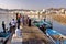 MUSCAT, OMAN - FEBRUARY 11, 2012: Fisherman at The Muttrah Fish docks early morning with Muttrah corniche in the Background