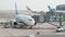 Muscat, Oman - May 6, 2019: Airport passengers boarding on a plane, people walking through jet bridge. Also termed