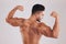 Muscle, bodybuilder and man flex, with natural body and confident with studio background. Muscular, young male and