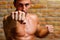 Muscle boxer shaped man fist to camera