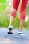 Muscle injury - woman running clutching calf muscle