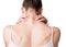 Muscle spasm, neck, trapezoid and shoulders pain. Female back in white top. Woman put her fingers on sore spots