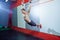 Muscle-up exercise young man doing intense cross fit workout at the gym on gymnastic rings.