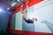 Muscle-up exercise young man doing intense cross fit workout at the gym on gymnastic rings.