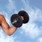 Muscled arm lifting weights