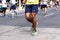 Muscled legs of a black male runner competing in an amateur race through the streets of Valencia, Spain