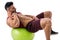 Muscleman exercising abs on an exercise ball