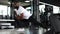 Muscular african man at the gym doing stretching exercises on the floor.