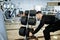 Muscular arab man training with dumbbells in modern gym