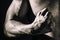 The muscular arm of a confident young man - a bodybuilder athlete, clenched into a fist. The concept of strength, exercise, health