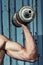 Muscular arm with dumbbell close up