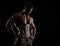 Muscular athlete bodybuilder man on a dark background