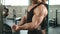 muscular athlete pumps biceps in the cable station . close up